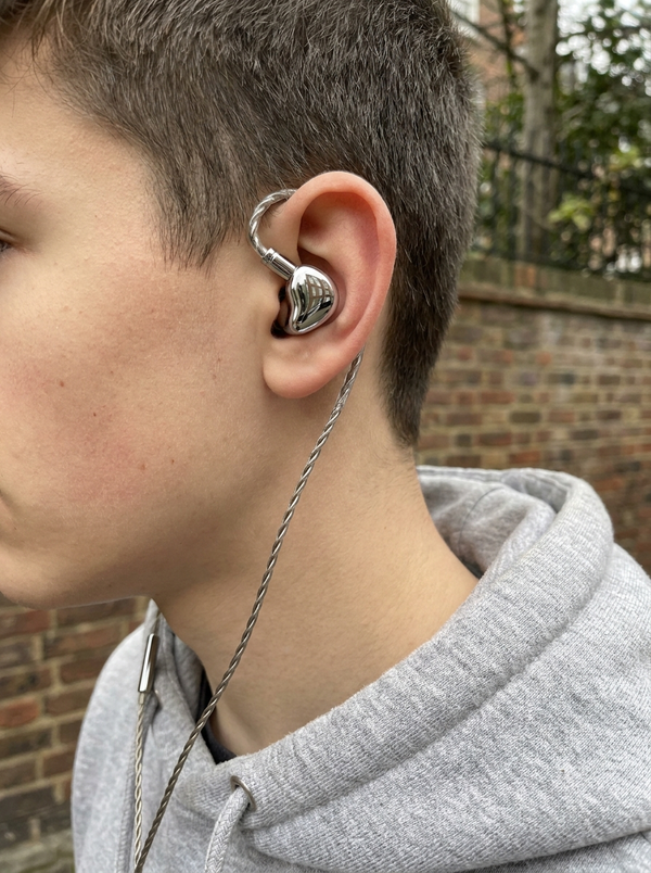Person wearing chrome earbud